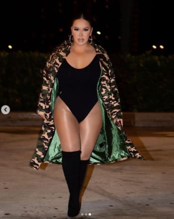 On top of a luxurious car Chiquis Rivera shows off legs in transparent stockings