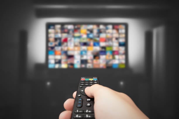 Video on demand, television streaming, multimedia, hand, remote control.