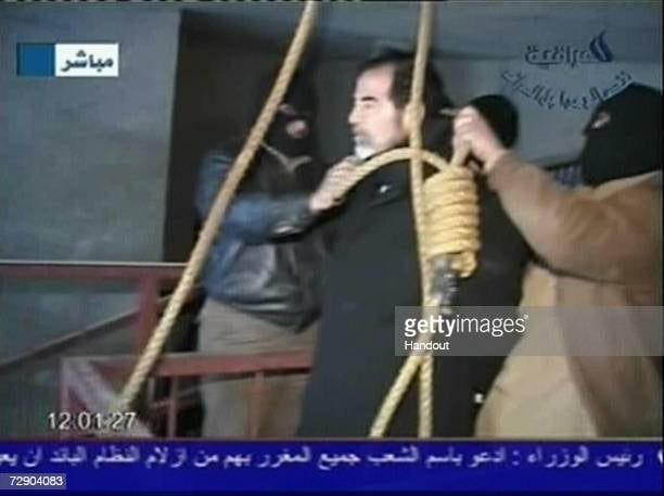 BAGHDAD, IRAQ - DECEMBER 30: In this television screen grab taken from Iraqi national television station Al-iraqia, a video shows the moments leading up to the execution of former Iraqi dictator Saddam Hussein standing on the gallows as he prepared for hanging, on December 30, 2006 in Baghdad, Iraq. The former Iraqi president was executed by hanging at 0600 (0300 GMT) in a secure facility in the Northern Baghdad suburb of Khadimeya. (Photo by Al-iraqia via Getty Images)