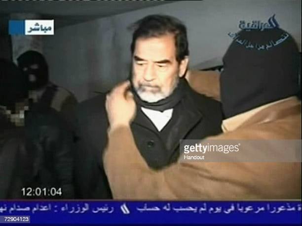 BAGHDAD, IRAQ - DECEMBER 30: In this television screen grab taken from Iraqi national television station Al-iraqia, a video shows the moments leading up to the execution of former Iraqi dictator Saddam Hussein as he is prepared for hanging, on December 30, 2006 in Baghdad, Iraq. The former Iraqi president was executed by hanging at 0600 (0300 GMT) in a secure facility in the Northern Baghdad suburb of Khadimeya. (Photo by Al-iraqia via Getty Images)