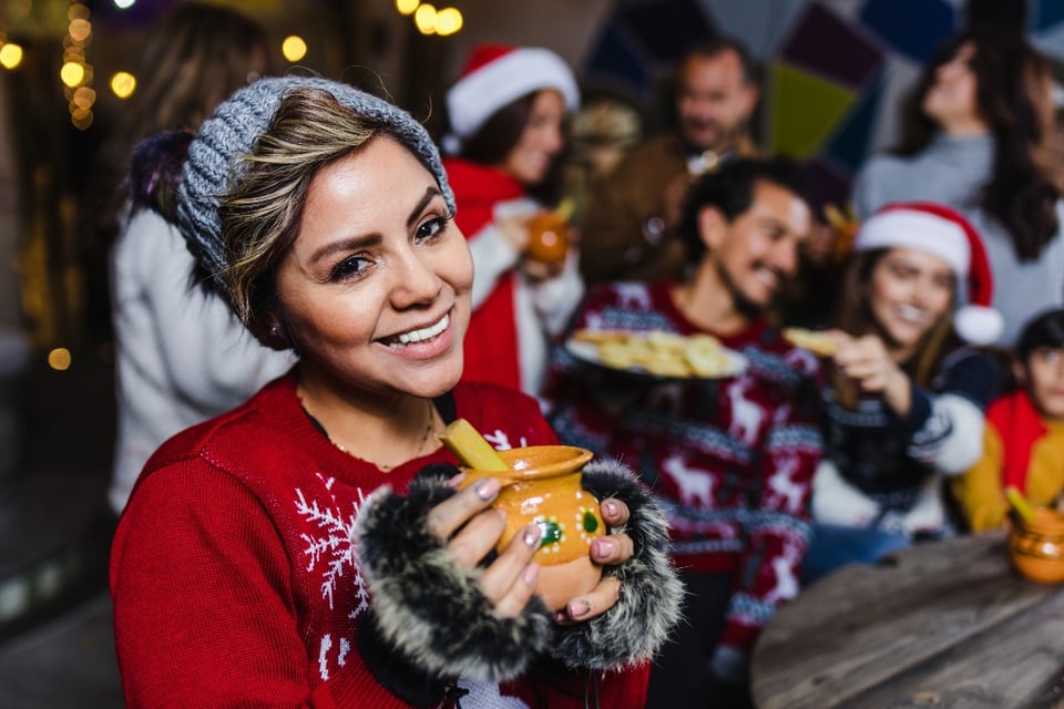 Christmas inn, Christmas party, woman drinking punch, Santa hats, MundoNOW