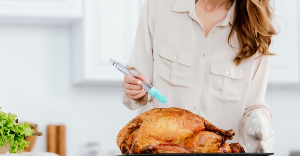 A woman preparing a turkey
