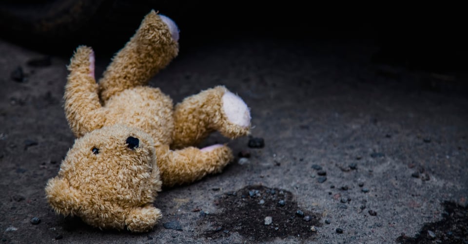 A teddy bear on the floor left behind by a killer