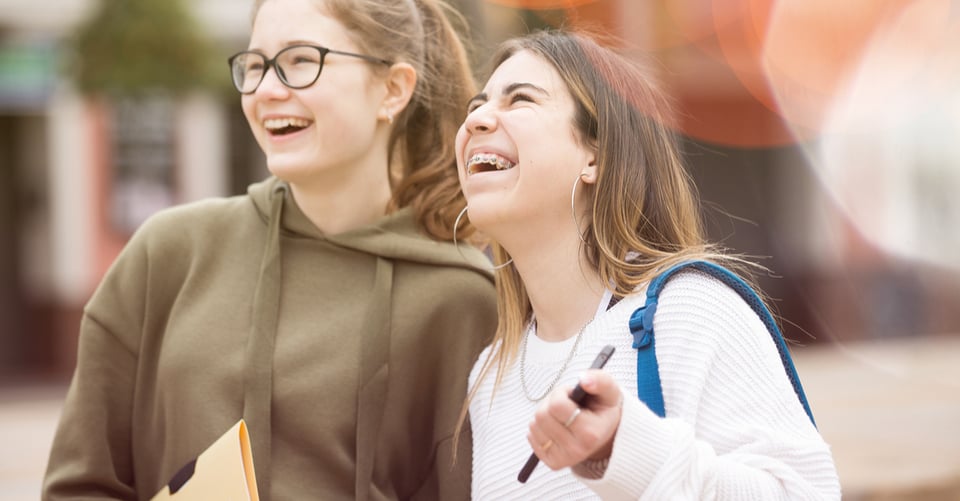 Two teenagers laughing