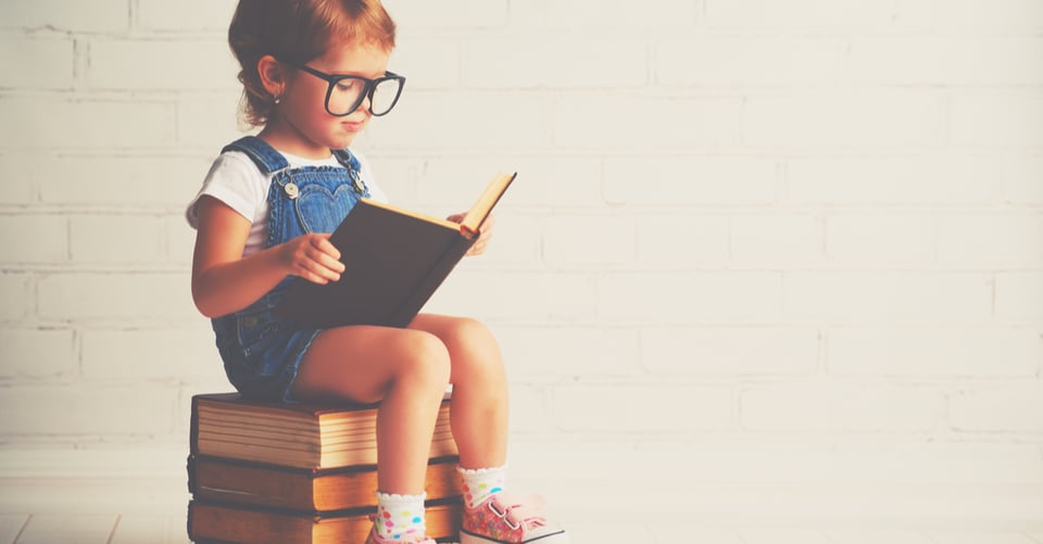 An infant with a book in hands