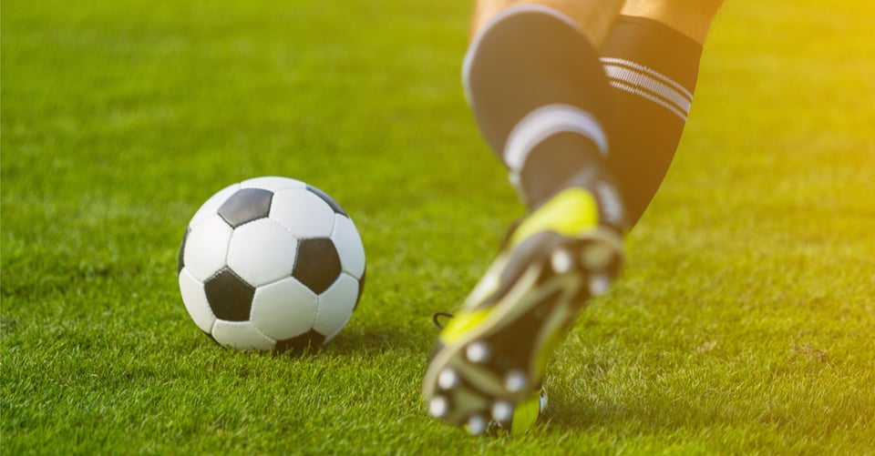 A soccer ball together with a player as an idea of a world cup
